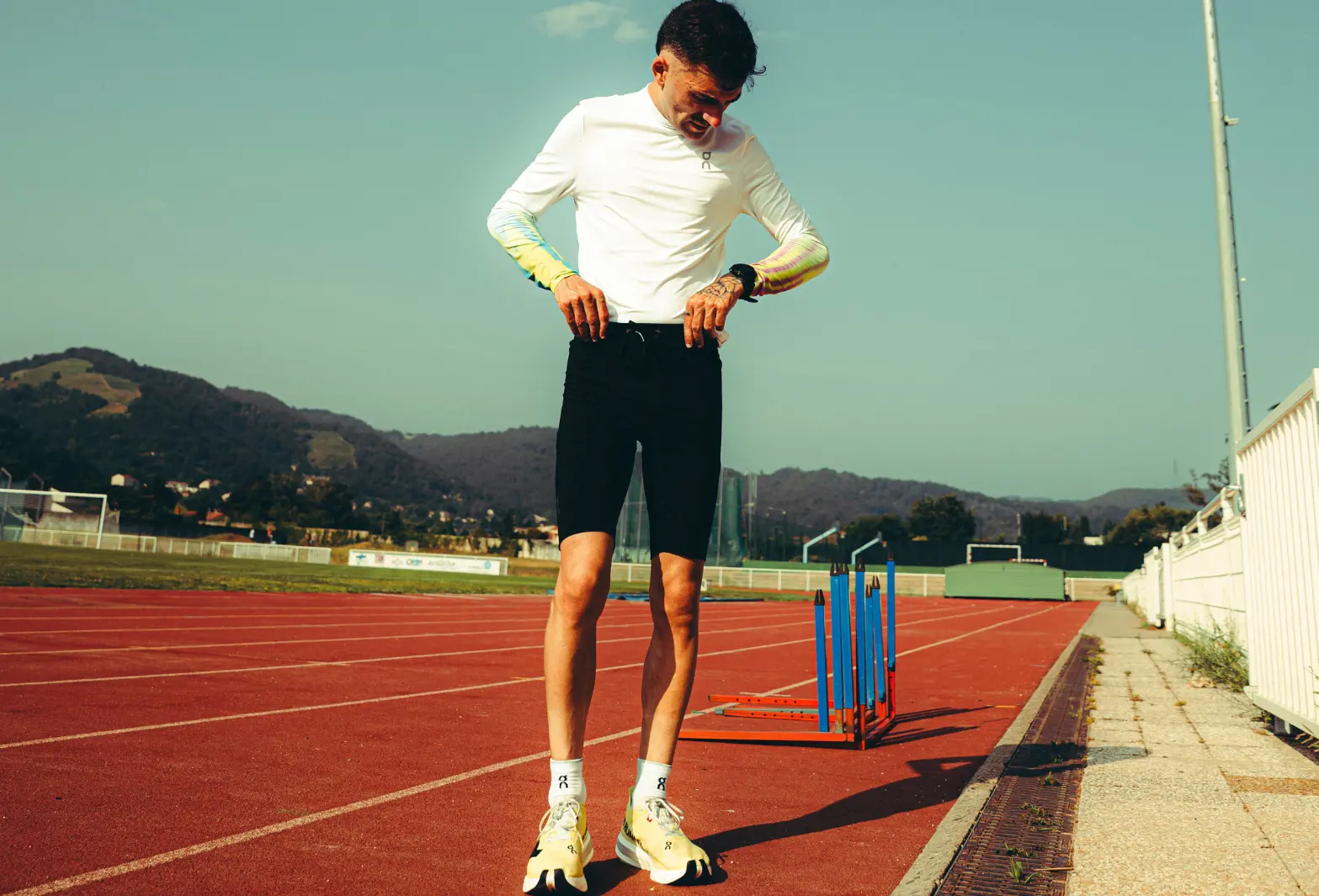 Athlete on the track, preparing for an intense workout, symbolizing pure Protéalpes sports nutrition.